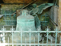 brompton cemetery, london,view inside the catacombs of 1838, built by baud.   the bell and angel appear to be from elsewhere in the cemetery.