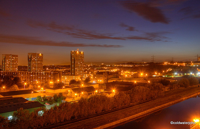 Summer evening by the Forth Clyde Canal overlooking Glasgow City Lights