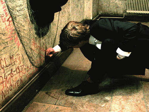 A friend of mine writes his name on the wall of the Zweetkamertje (Sweat Room) of Leiden University