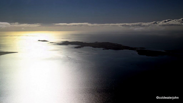 Aerial: Gigha Island and the west into setting sun