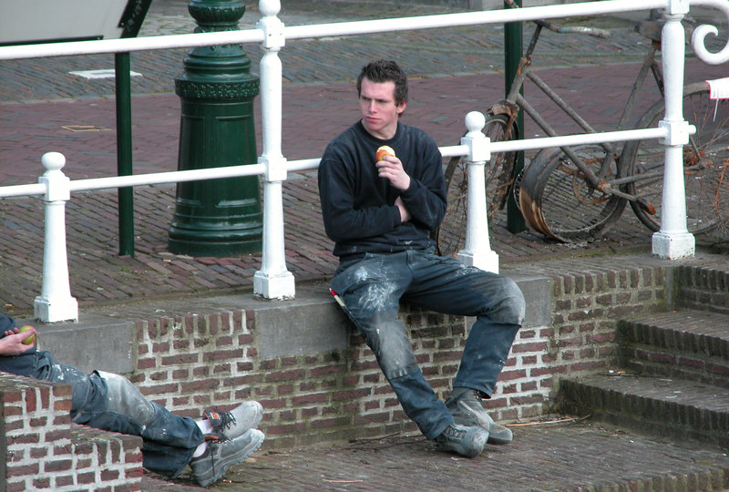 Young worker eating an apple for lunch