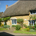 thatched cottage with roses