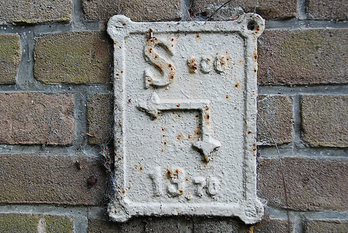 An old sign to indicate a power cable?