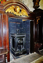 petworth house,c19 stove in a niche in the c17 woodwork