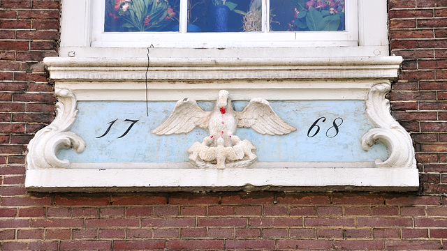 Gable stone of a pelican and young