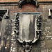 bow church, london,monument of 1763 to john cock?, collar maker to his majesty and his royalist father, on the outside of the south aisle , which was refaced in 1794