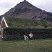 Turf-Roofed Cafe Beneath a Lava Mountain