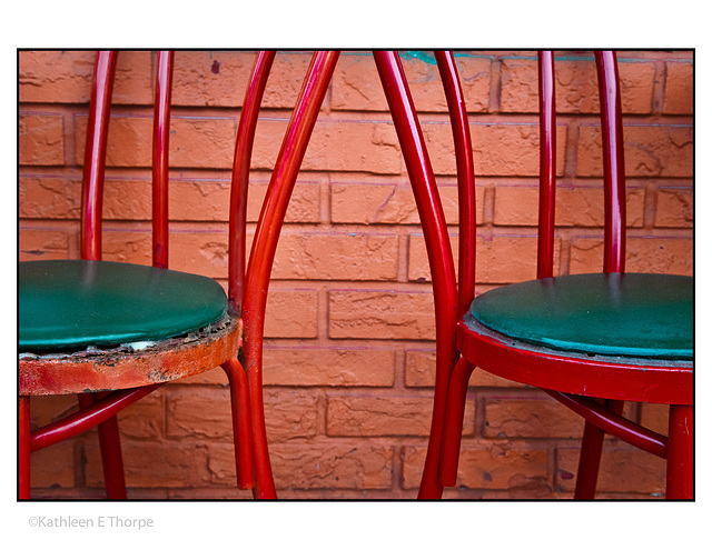 Red Chairs against brick wall