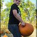 Mohawk Boy Holding Up Pumpkin