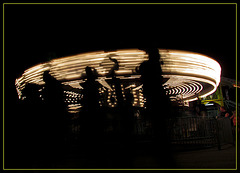 Carousel with People Walking Past
