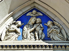 st.mary eversholt street, camden, london, late c19 sculpture added to the west doorway, prob. by reade in 1890. ,      tympanum with its semi classical leaf motif