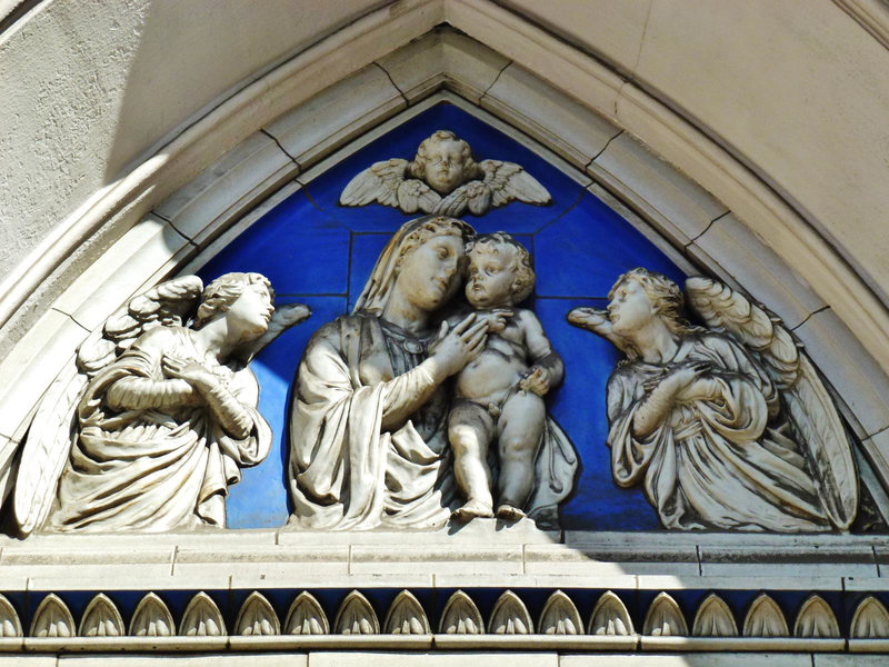 st.mary eversholt street, camden, london, late c19 sculpture added to the west doorway, prob. by reade in 1890. ,      tympanum with its semi classical leaf motif