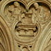 canterbury cathedral, c14detail of monks at lecterns and disputing fill the spandrels of the canopy on the tomb built for archbishop meopham , who died in 1333 makes a screen across the entrance to the chapel of st.anselm. the canopy is an afterthought, a