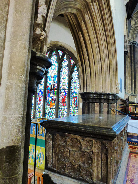 wimborne minster, dorset,arch between the raised chancel and the north chancel aisle chapel, built c.1250, reusing carved figures of c.1200.  the  purbeck tomb chest is that of the marchioness of exet