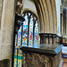 wimborne minster, dorset,arch between the raised chancel and the north chancel aisle chapel, built c.1250, reusing carved figures of c.1200.  the  purbeck tomb chest is that of the marchioness of exeter, + 1557, gertrude, wife of henry courtenay, earl of