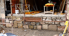 Completed stone facework below south-facing window including the old stone door lintel, inscribed "Dairy 1850"