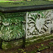 barking church, essex,tomb chest of captain john bennett, 1706, with a worn gorgon's head on the shield backed by a trophy of arms. he has an ornate monument in the church too, both show his ship