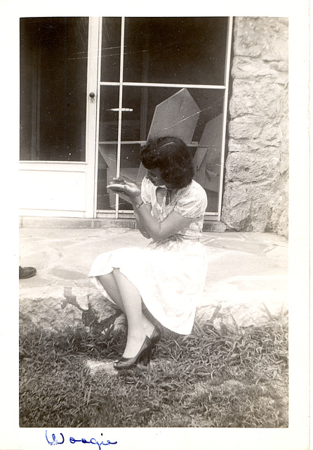 "Woogie," is the name of my mother-in-law's pet flying squirrel, held in the palm of her hand. C. 1942