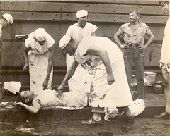 Officers and men of the USS Catamount particiapte in a Crossing the Line ceremony markin the crossing of the Equator.  Spring, 1945 in the Pacific