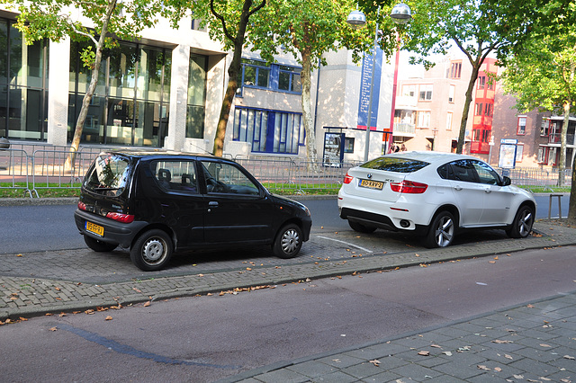 Small black car and silly big white car