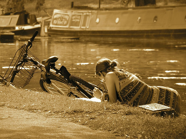 Girl reading a book by the Cam