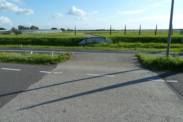 Old Roman road intersected by a modern Dutch road