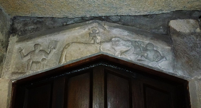 tarrant rushton church, dorset,lamb of god in the middle, blessing priest? seated with bible at left, and seated man with bird and bible at right,  . in its damaged state, the meaning of this early c1