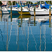 Sailing boats' masts reflections