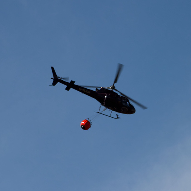 Torridon fire 7: Helicopter with water bucket attached