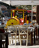 A Bit Close! Tourist Train Passing a Taverna