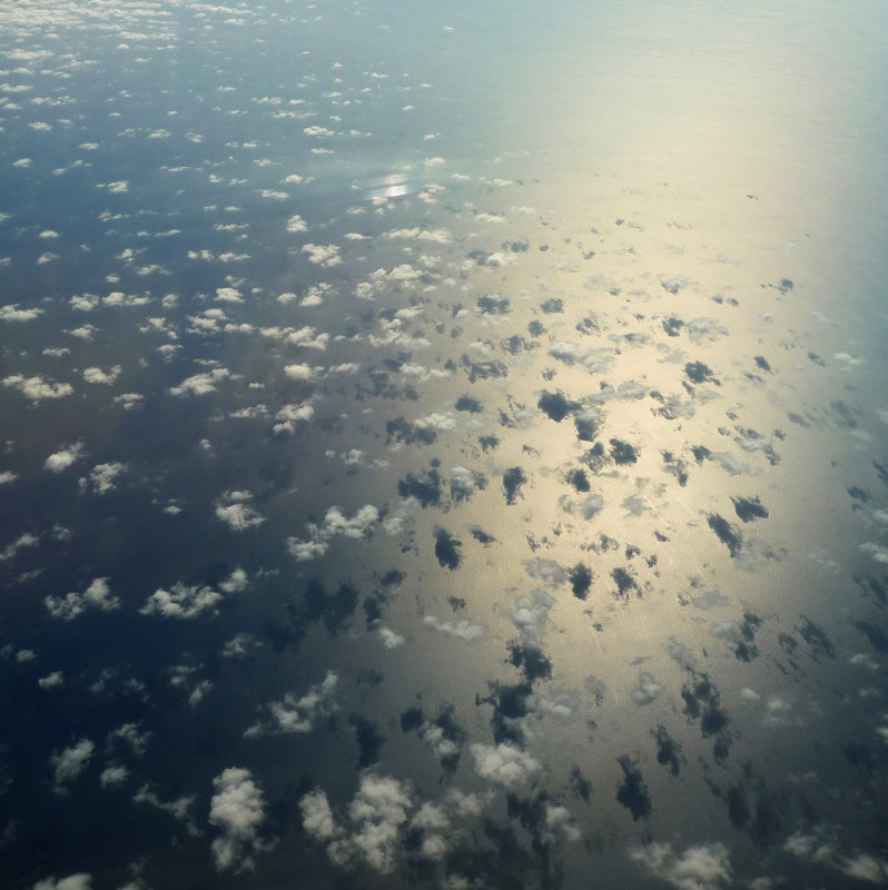 clouds and their shadows on the sea