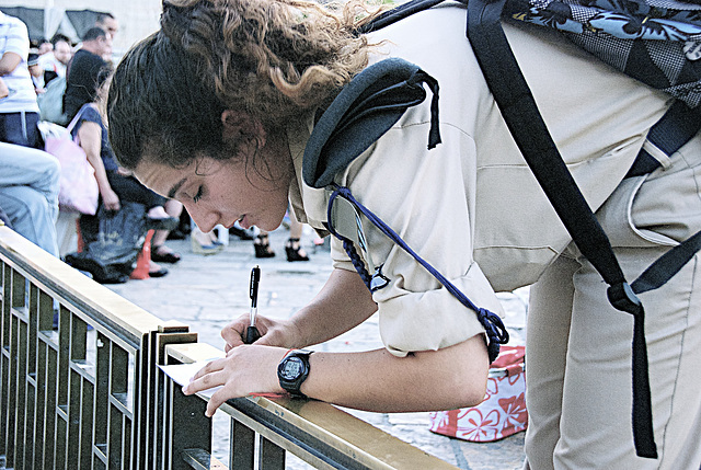 an Airforce young female soldier while taking notes...