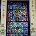 Intricate stained glass window above the altar