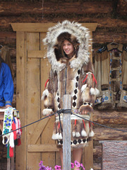 Authentic parka. Mostly muskrat with wolverine around the face and a "sunburst" of wolf.
