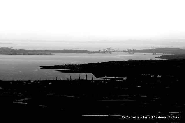 Aerial - The Forth Bridge 20 miles away, from overhead the M80, on a murky morning flight out of Cumbernauld