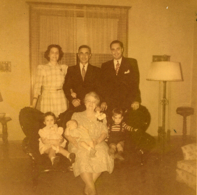 Christmas, 1949. Doris, Rudy, Carl, seated on the davenport (and that's a word you don't hear anymore): Joanne, Karen, Great Grandma Grossenbach, Ricky