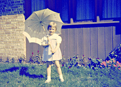 My sister with my grandmother's heirloom parasol in the Vintage Photos Theme Park, c. 1953