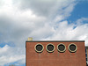 Four Portholes and a Cloudy Sky