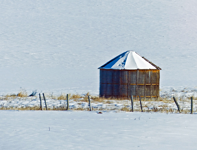 A farmer's wooden storage bin