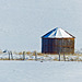 A farmer's wooden storage bin