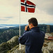 A tourist takes pictures from the top of Mount Ulriken, Bergen, Norway
