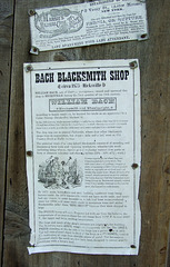 Signs on the Bach Blacksmith Shop in Old Bethpage Village Restoration, May 2007