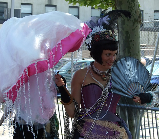 Mermaid with Parasol and a Pirate Fan at the Coney Island Mermaid Parade, June 2010