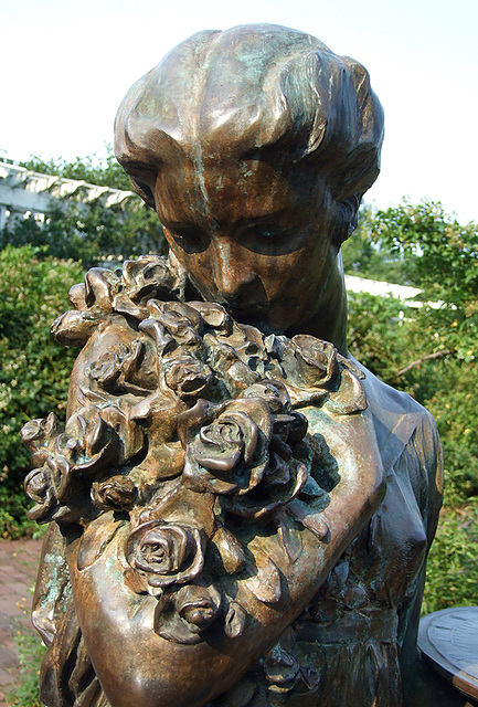 Detail of the Bronze Sculpture of a Girl Holding a Sundial in the Rose Garden in the Brooklyn Botanic Garden, July 2008