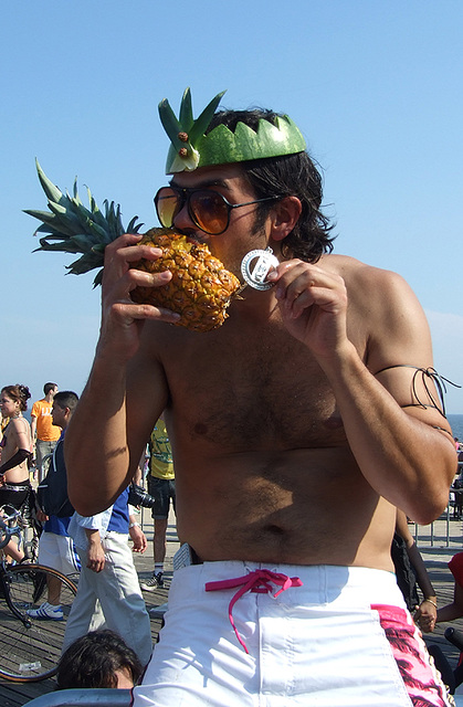 A Guy Eating a Pineapple at the Coney Island Mermaid Parade, June 2008