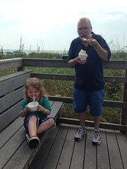 Kolton eating ice cream with Papa at the beach