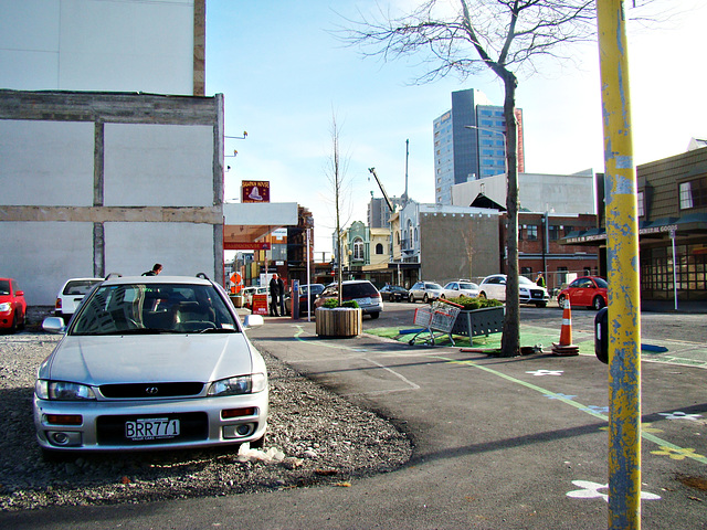 Cars parked where buildings once stood