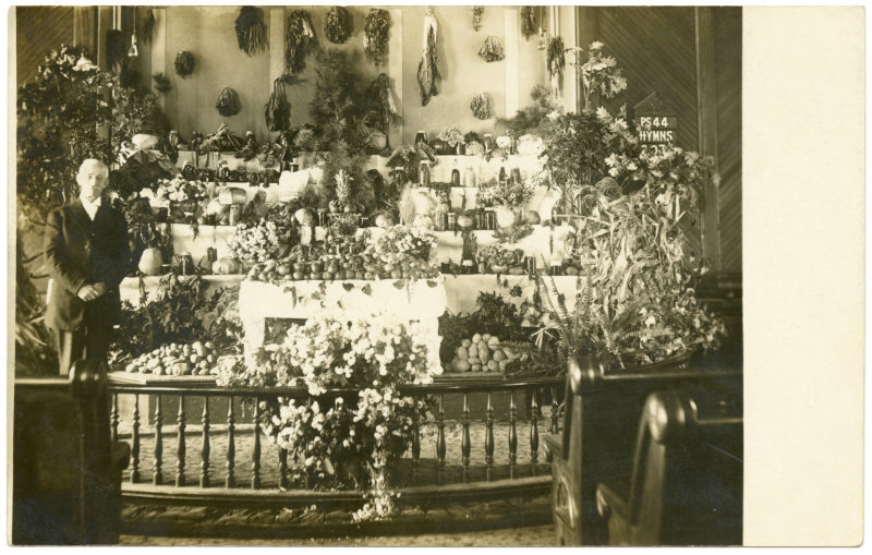 Man with Harvest Home Display