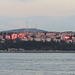 Sailing from Istanbul, windows of the Asian side of the city blaze in the setting sun.