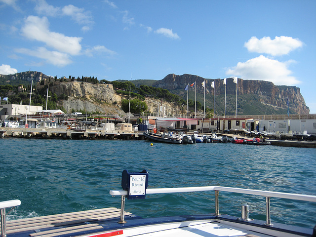 The port of Cassis with nearby limestone cliffs.